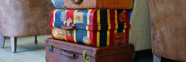 Three suitcases stacked and ready to travel to Abruzzo Italy.